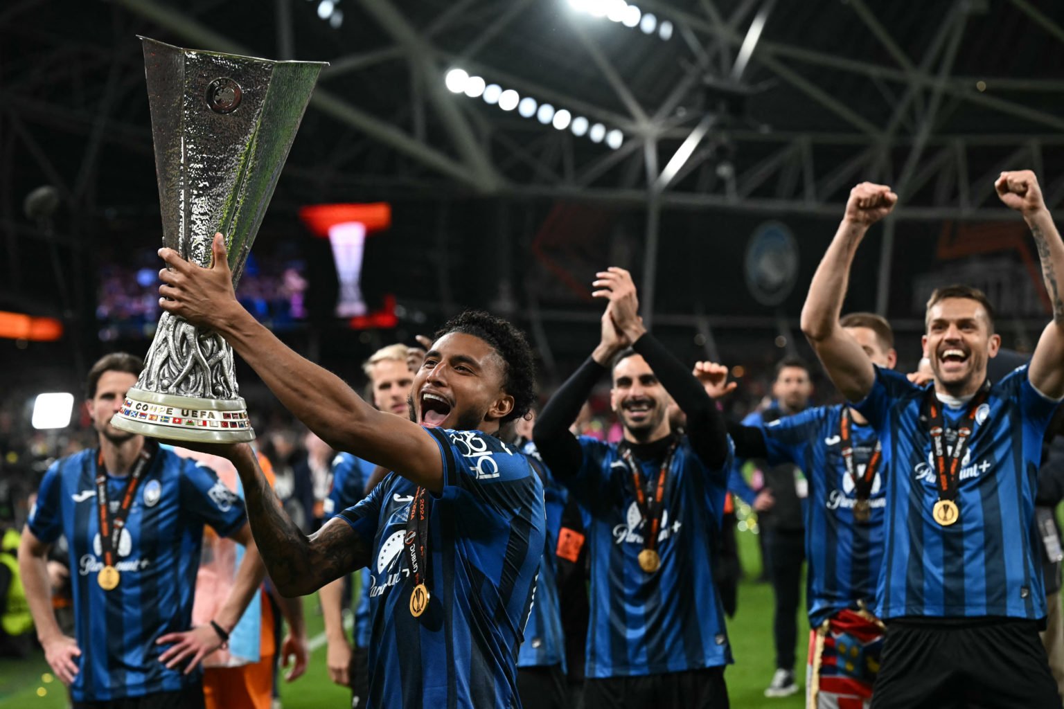 Atalanta's Brazilian midfielder #13 Ederson holds up the trophy as Atalanta's players celebrate after the UEFA Europa League final football match b...