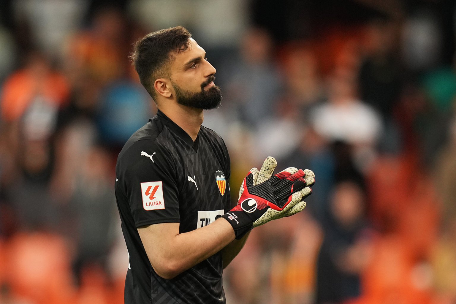 Giorgi Mamardashvili of Valencia CF applauds the fans at full-time following the team's defeat in the LaLiga EA Sports match between Valencia CF an...