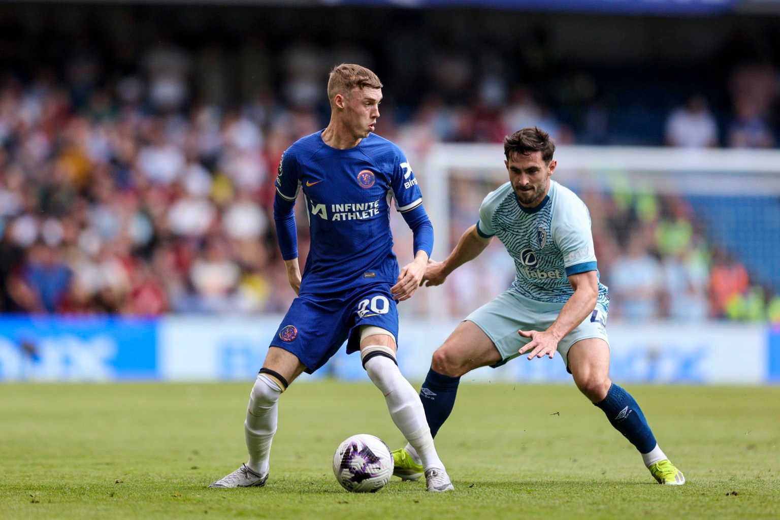 Cole Palmer of Chelsea is closed down by Lewis Cook of Bournemouth during the Premier League match between Chelsea FC and AFC Bournemouth at Stamfo...