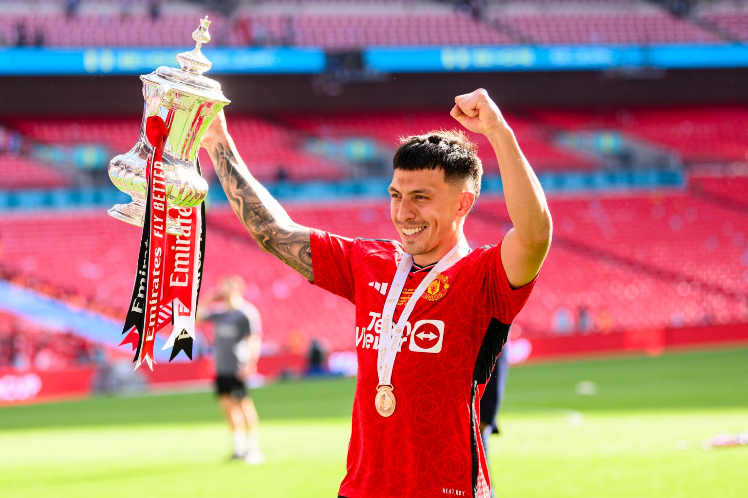 Lisandro Martínez of Manchester United raises the winners trophy while celebrates with his team and fans after winning Manchester City during the E...