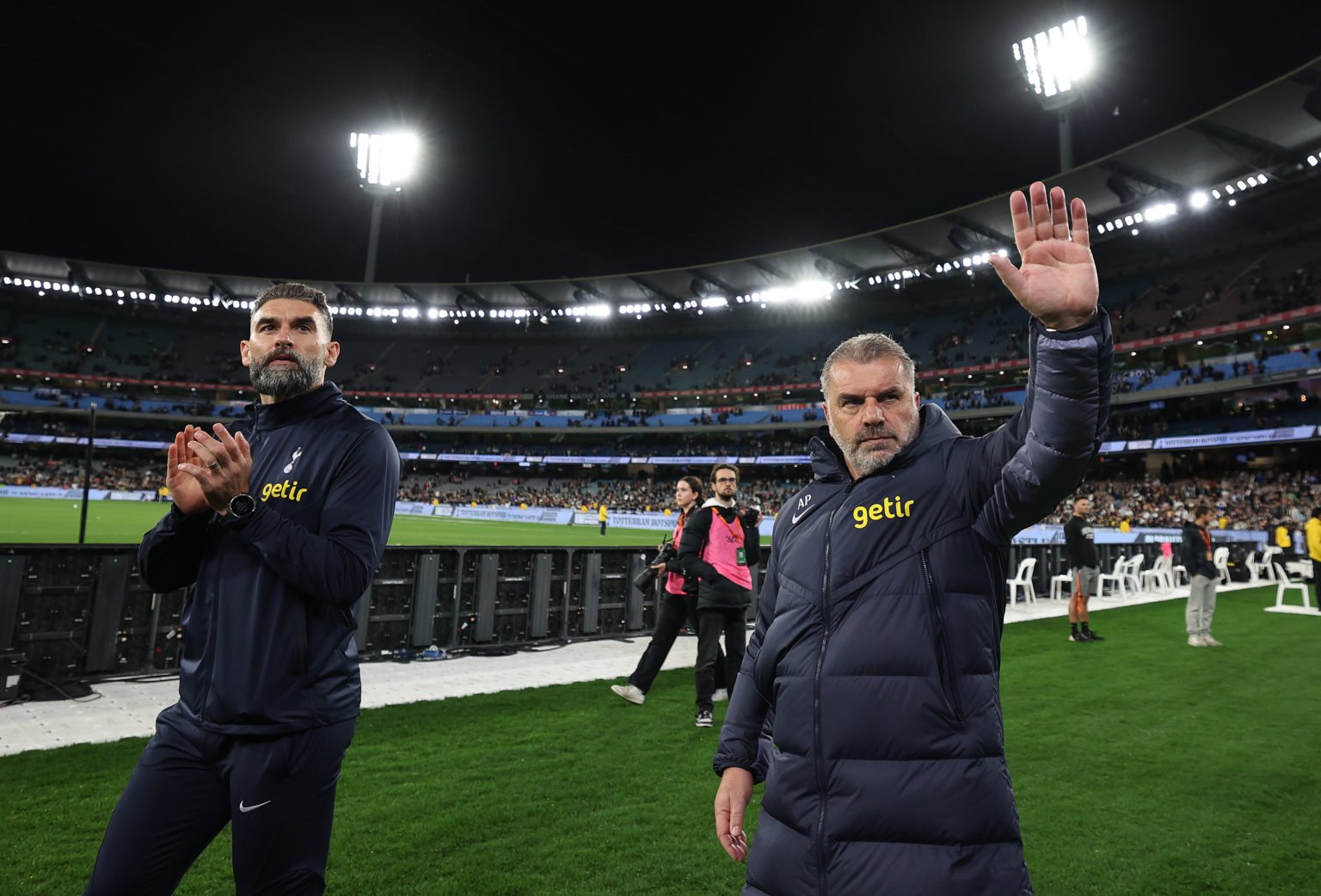 Ange Postecoglou, coach of Tottenham Hotspur and assistant Mile Jedinak acknowledge the crowd after the exhibition match between Tottenham Hotspur ...