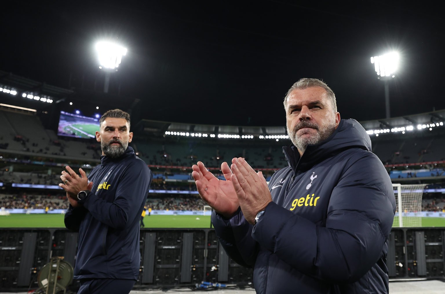 Ange Postecoglou, coach of Tottenham Hotspur and assistant Mile Jedinak acknowledge the crowd after the exhibition match between Tottenham Hotspur ...