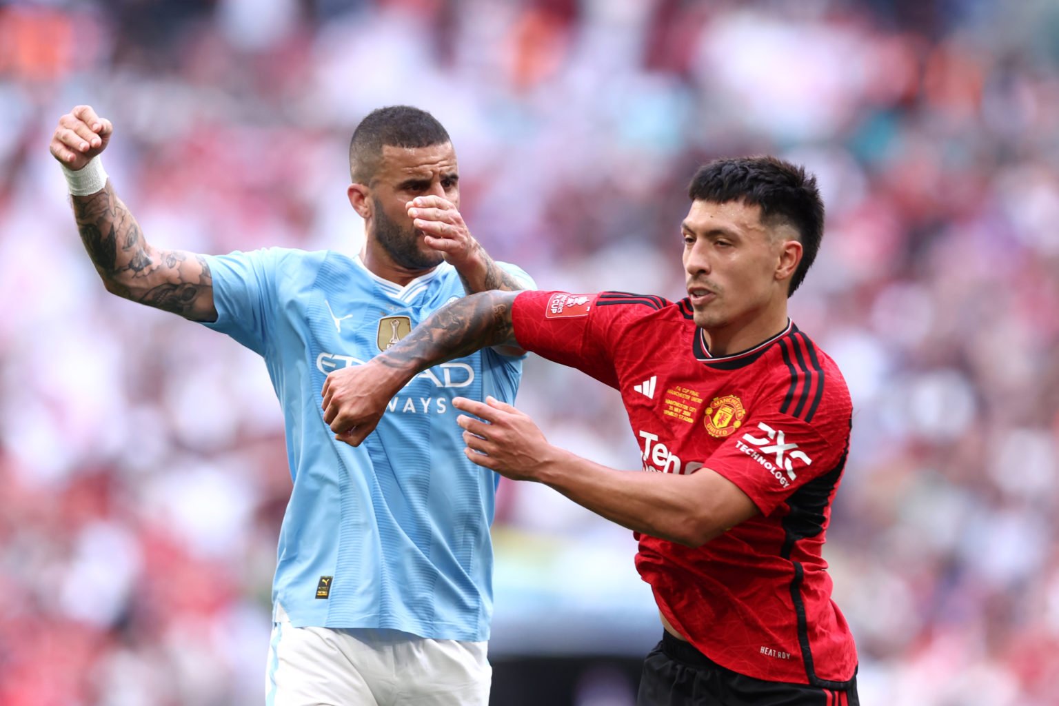 Kyle Walker of Manchester City and Lisandro Martinez of Manchester United clash during the Emirates FA Cup Final match between Manchester City and ...