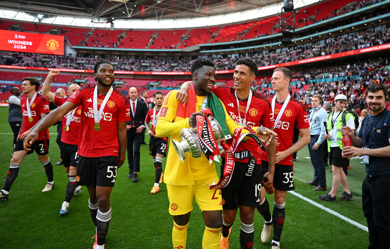 Andre Onana and Raphael Varane of Manchester United celebrate with the celebrate with the Emirates FA Cup Trophy after the team's victory in the Em...