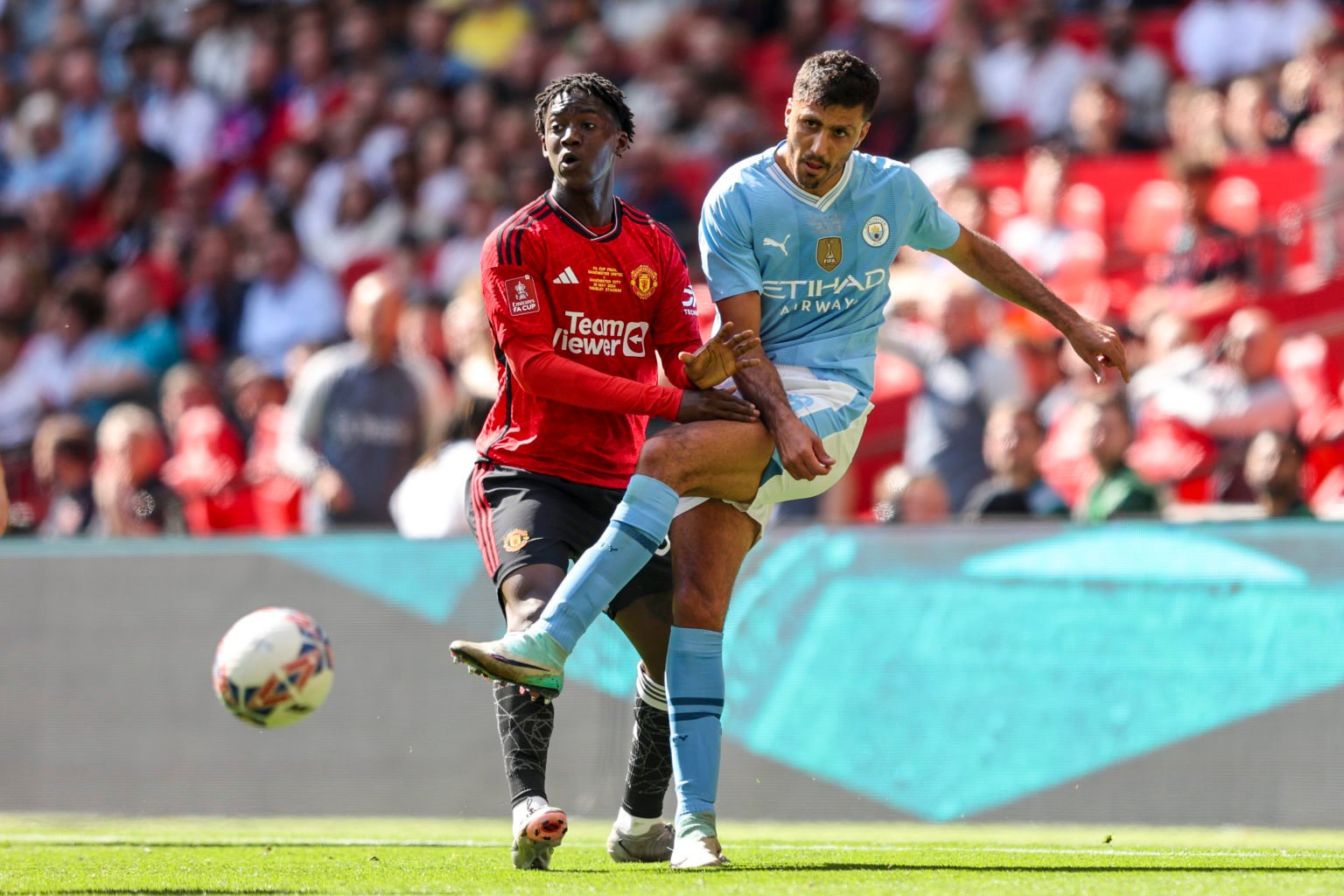 Kobbie Mainoo of Manchester United and Rodri of Manchester City during the Emirates FA Cup Final match between Manchester City and Manchester Unite...