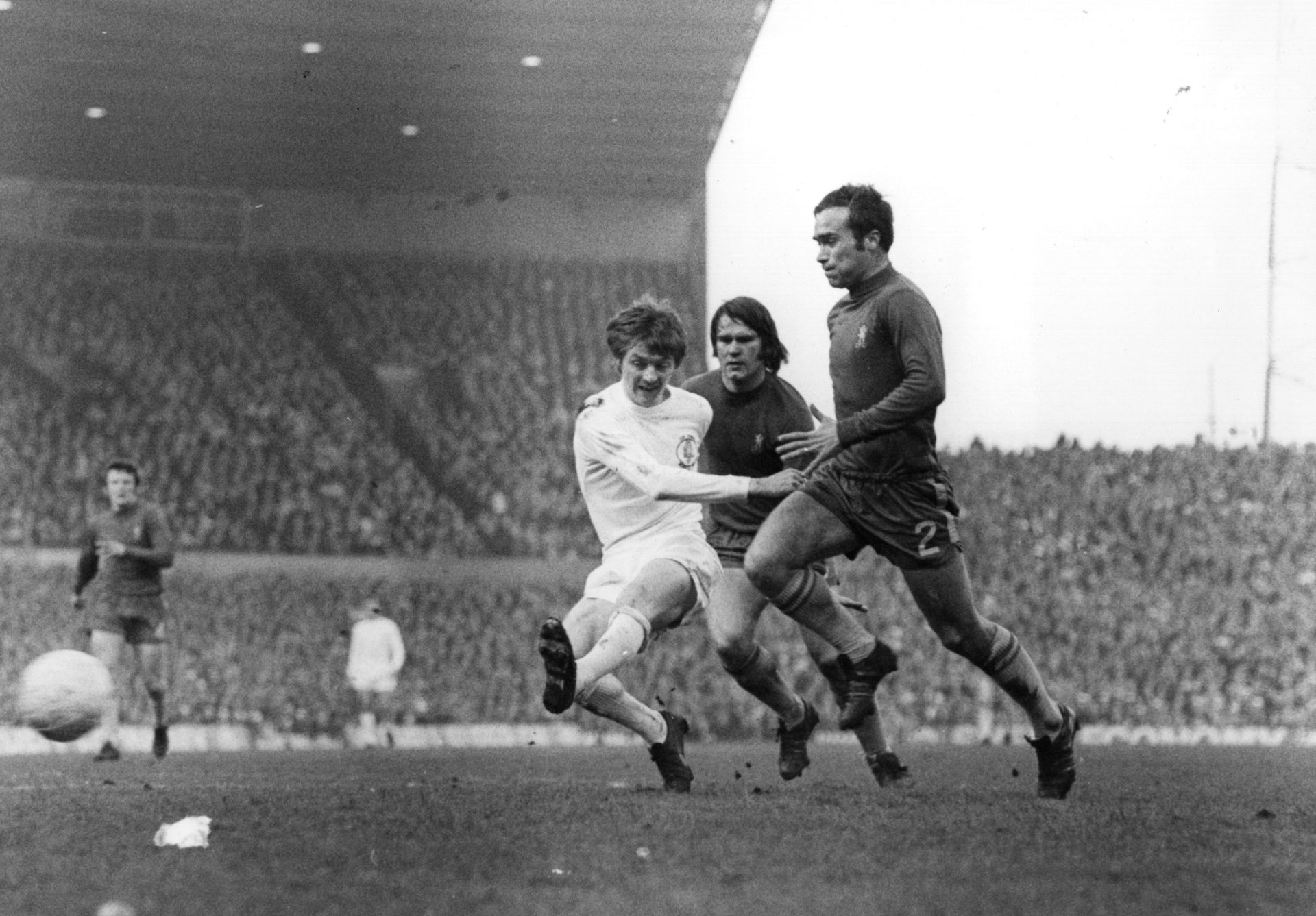 Alan Clarke (left) of Leeds United takes a shot at the Chelsea goal as Chelsea defenders Ron Harris (left) and Dave Webb approach, during the FA Cu...