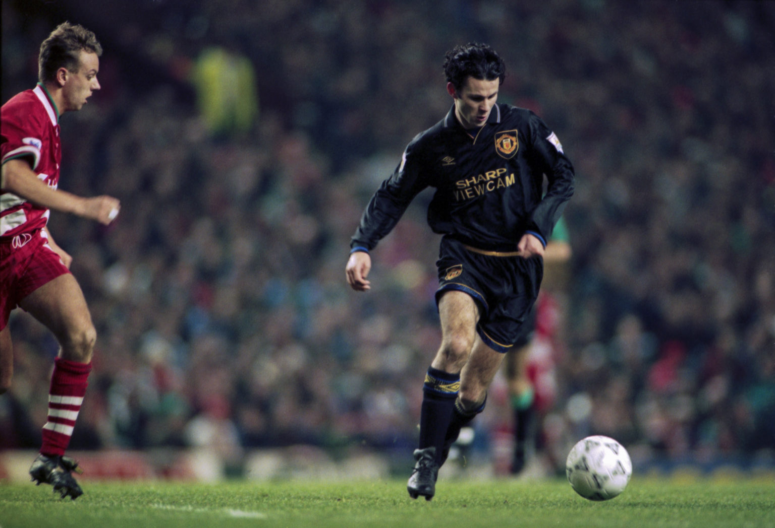 Welsh footballer Ryan Giggs (right) of Manchester United moves away from Rob Jones of Liverpool, during an English Premier League match at Anfield,...