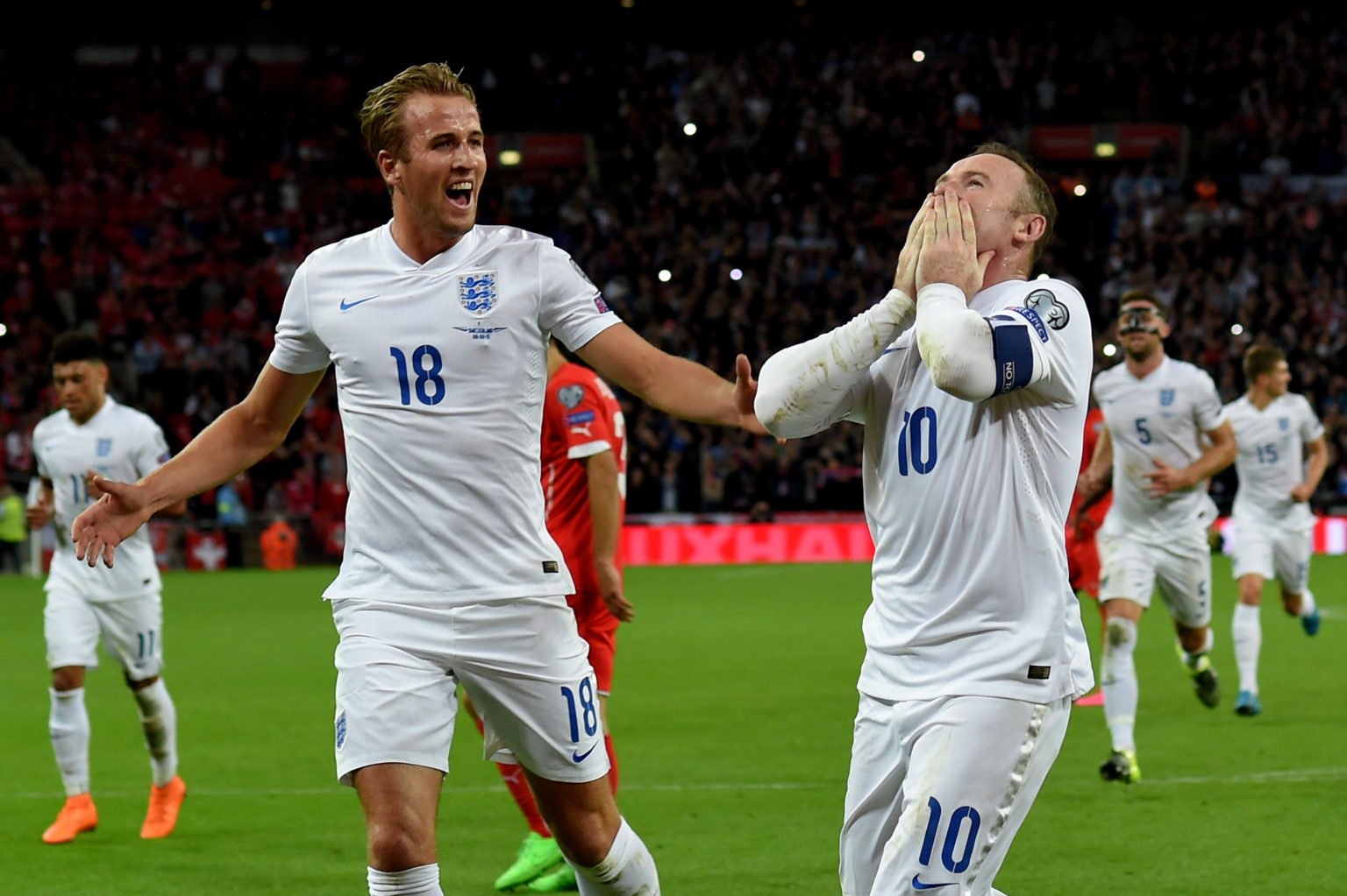 Wayne Rooney of England celebrates scoring his team's second goal breaking the record of 49 goals set by Sir Bobby Charlton with Harry Kane (L) dur...