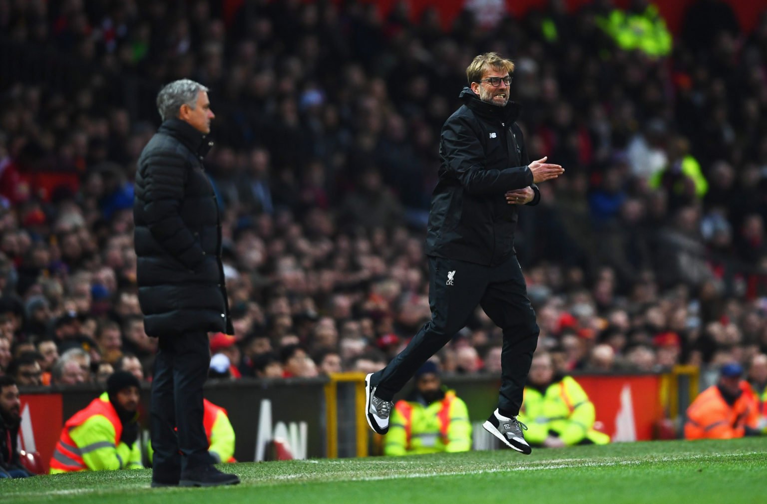 Jurgen Klopp manager of Liverpool reacts as Jose Mourinho manager of Manchester United looks on during the Premier League match between Manchester ...