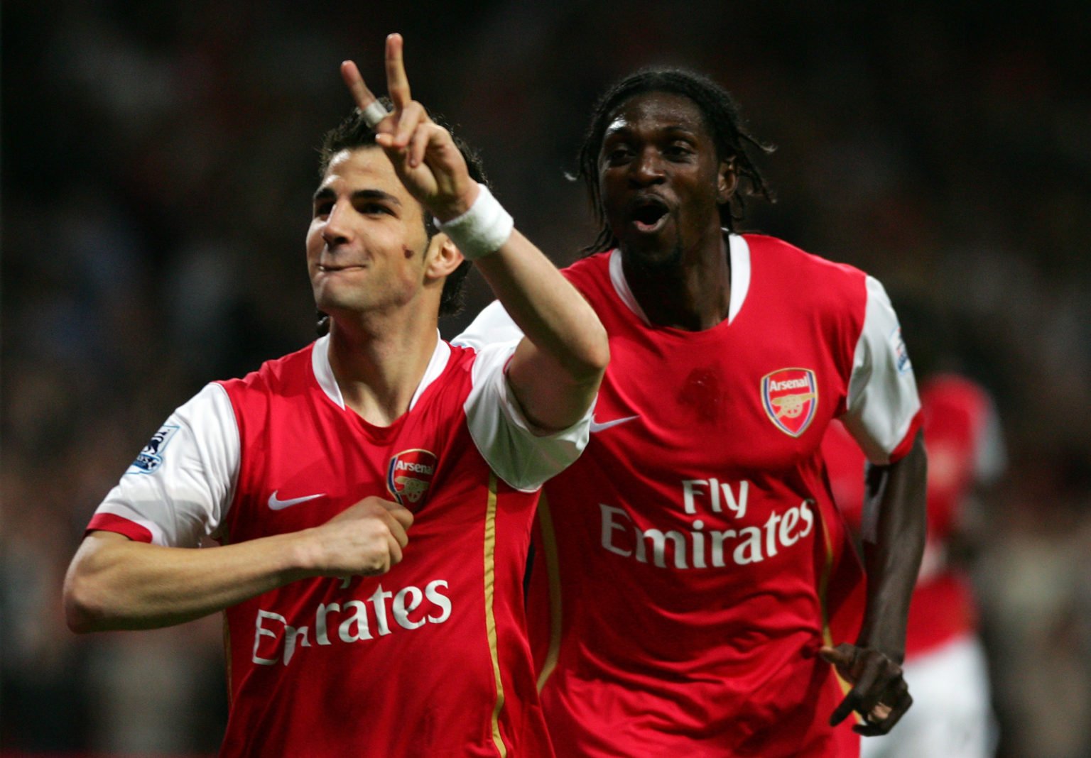 Cesc Fabregas (L) of Arsenal celebrates after he scores his teams second goal of the game with team mate Emmanuel Adebayor during the Barclays Prem...