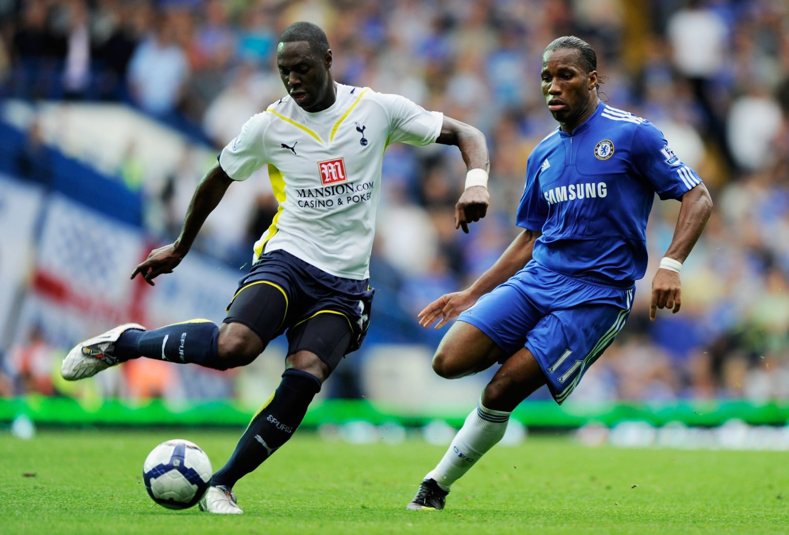 Ledley King of Spurs clears the ball as Didier Drogba of Chelsea closes in during the Barclays Premier League match between Chelsea and Tottenham H...