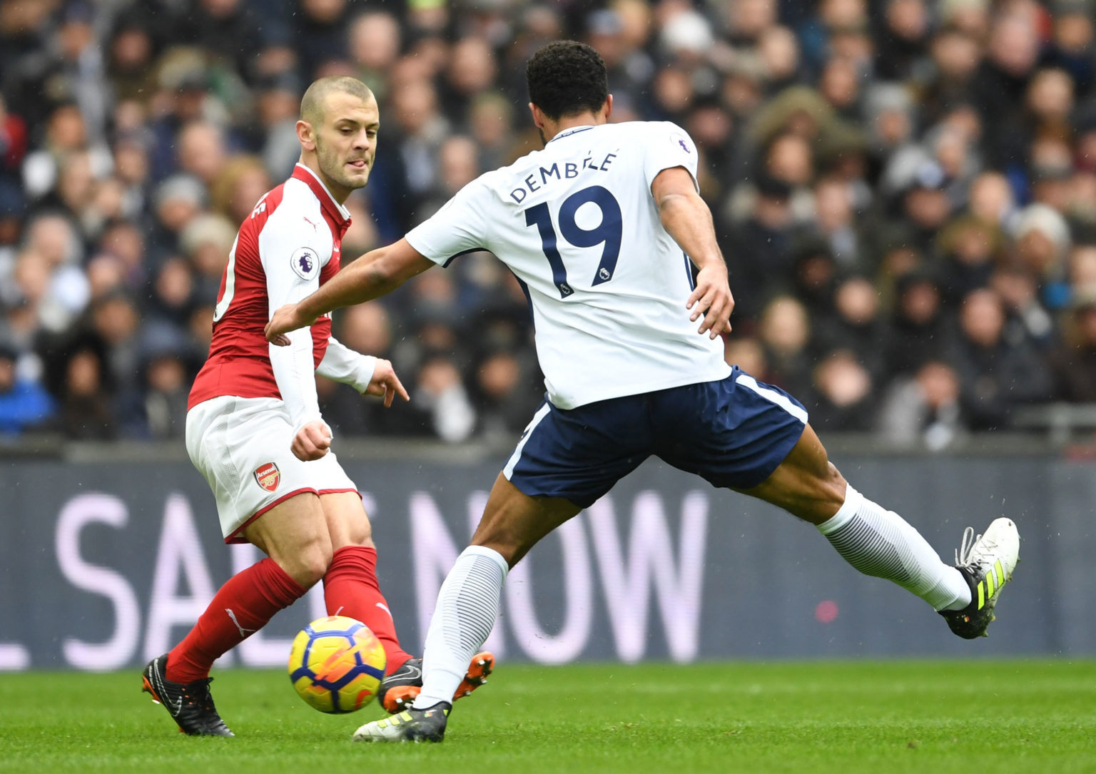 Jack Wilshere of Arsenal takes on Mousa Dembele of Tottenham during the Premier League match between Tottenham Hotspur and Arsenal at Wembley Stadi...