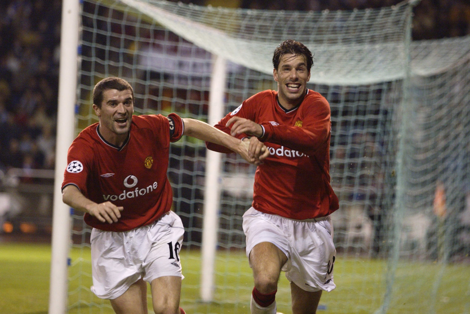 Ruud van Nistelrooy of Manchester United celebrates scoring the second goal with team-mate Roy Keane during the UEFA Champions League quarter-final...