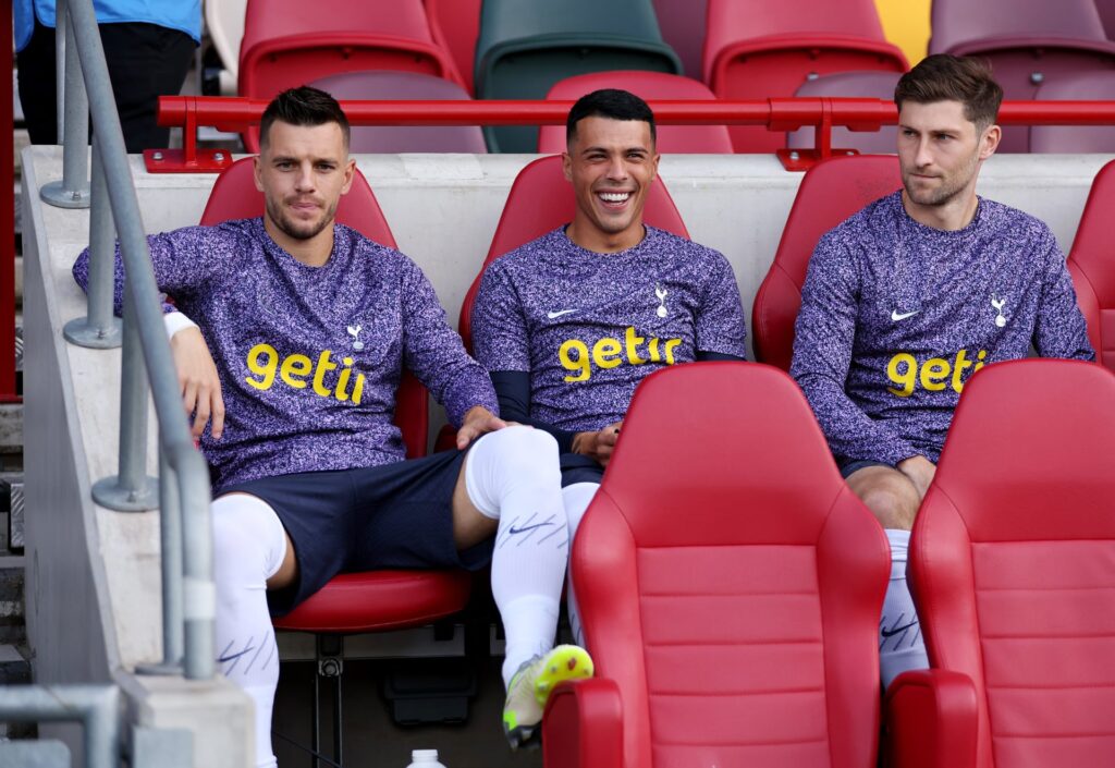 Giovani Lo Celso, Pedro Porro and Ben Davies of Tottenham Hotspur look on from the substitute bench prior to the Premier League match between Brent...