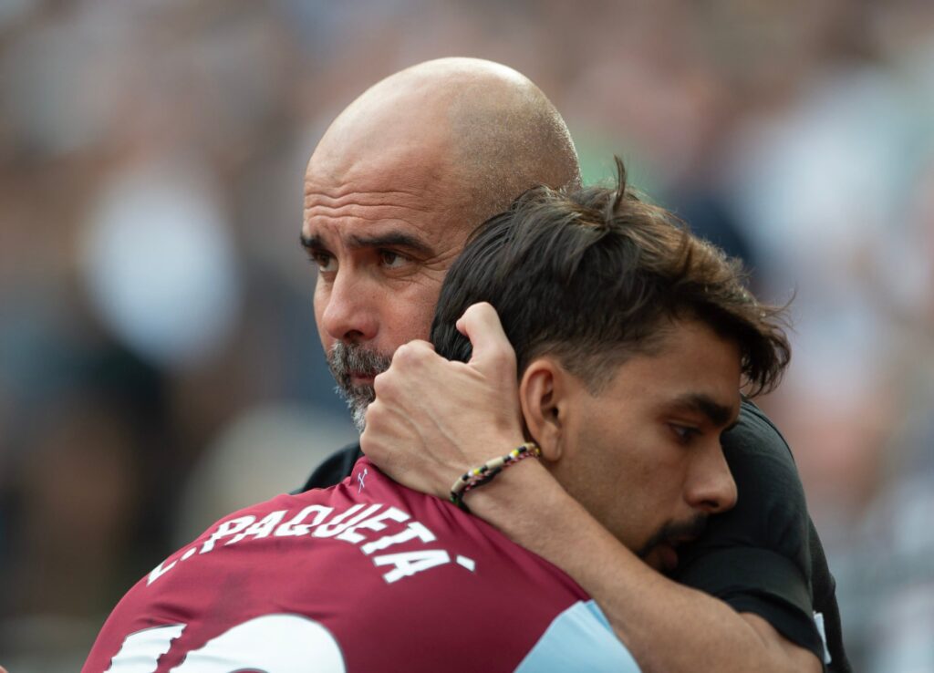 Manchester City Manager Pep Guardiola (R) and Lucas Paqueta of West Ham United embrace prior to the Premier League match between West Ham United an...