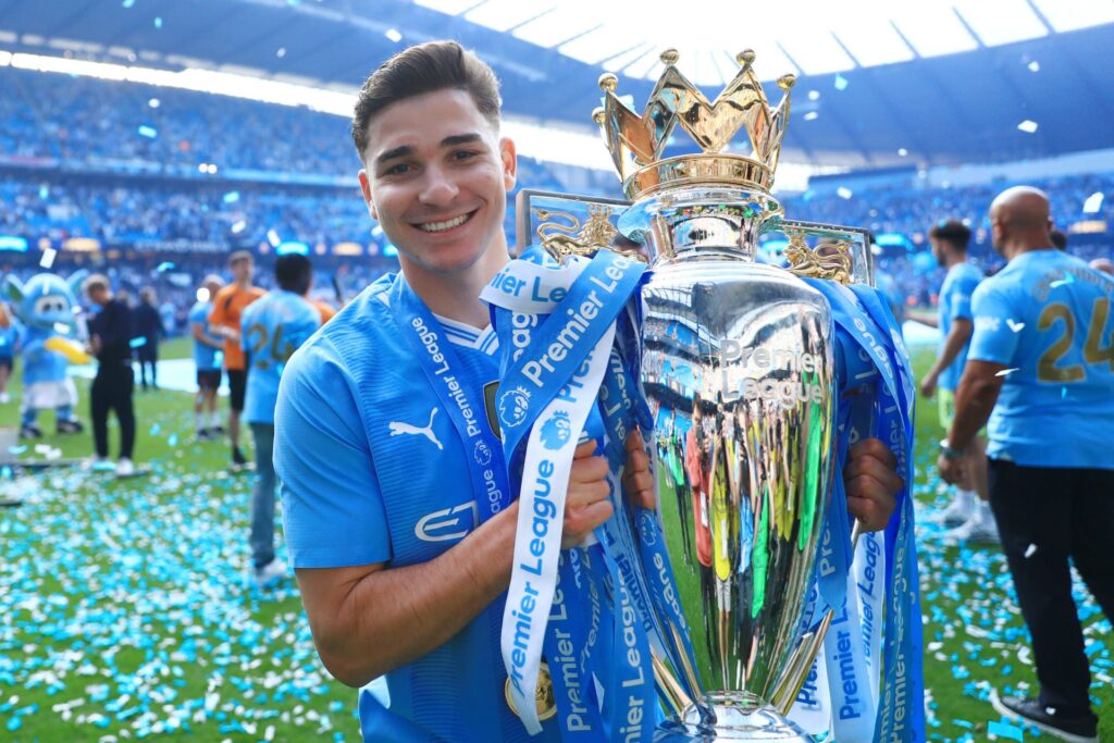 Julian Alvarez of Manchester City holds the trophy after the Premier League match between Manchester City and West Ham United at Etihad Stadium on ...