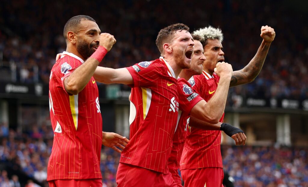 Diogo Jota of Liverpool (2R) celebrates scoring his team's first goal with teammates Mohamed Salah (L), Andy Robertson and Luis Diaz during the Pre...