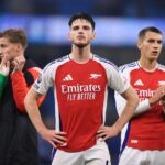 Declan Rice of Arsenal (C) and Jakub Kiwior of Arsenal (R) look dejected after the Premier League match between Manchester City FC and Arsenal FC a...