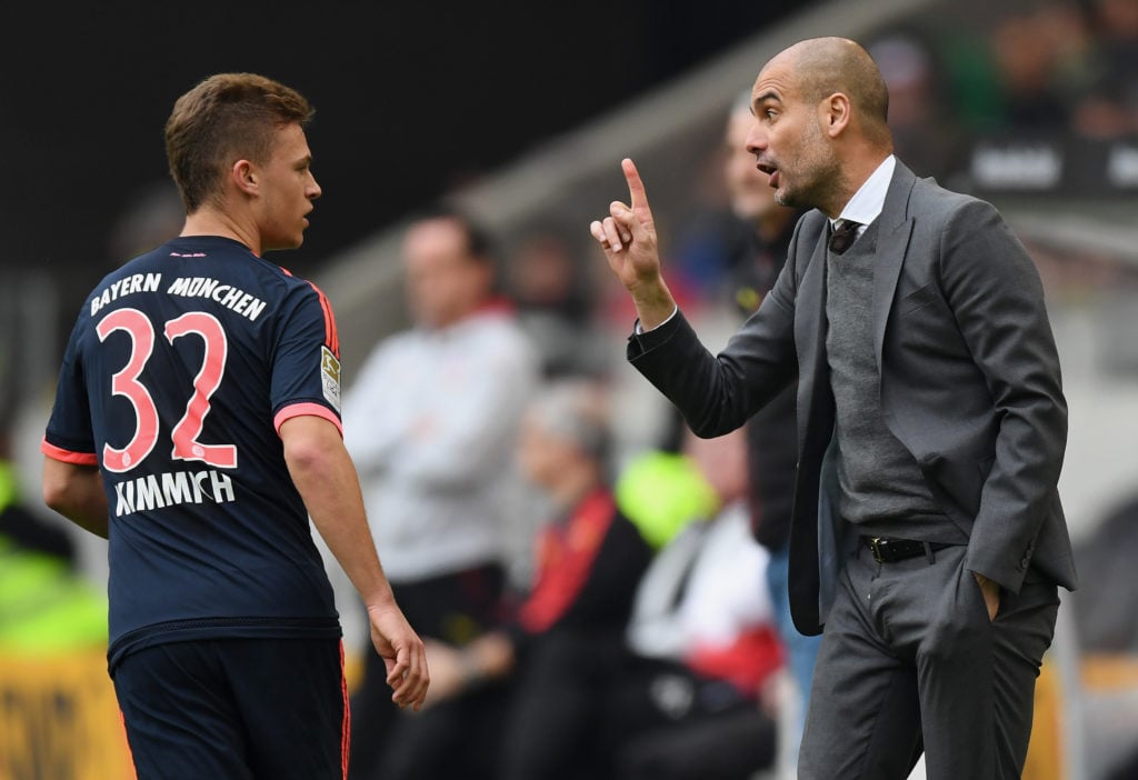 Head coach Pep Guardiola of Muenchen speaks with Joshua Kimmich of Muenchen during the Bundesliga match between VfB Stuttgart and FC Bayern Muenche...