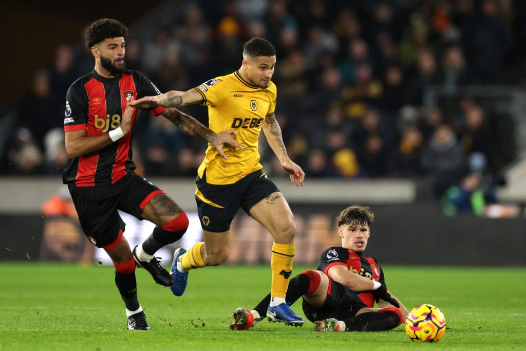 Joao Gomes of Wolverhampton Wanderers is challenged by Philip Billing and Milos Kerkez of AFC Bournemouth during the Premier League match between W...