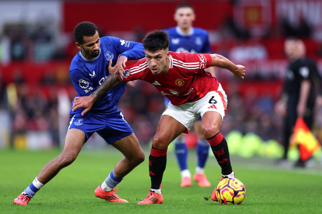 Lisandro Martinez of Manchester United is challenged by Iliman Ndiaye of Everton during the Premier League match between Manchester United FC and E...