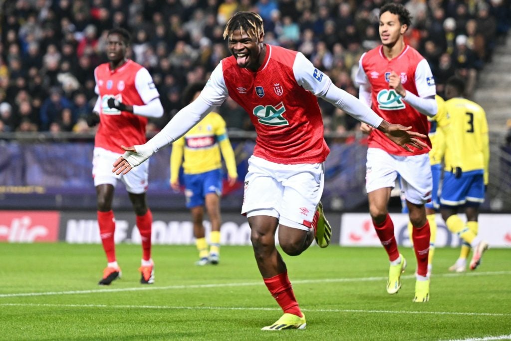 TOPSHOT - Reims' Ivorian defender #05 Emmanuel Agbadou (C) celebrates after scoring a goal during the French Cup round of 32 football match between...